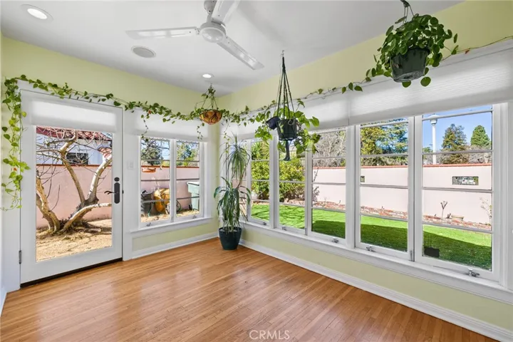 Sun Room/Office: windows galore, interior pull-down screens, wide sculpted mouldings, recessed dimmable ceiling can lights, ceiling speaker for sound system, view to astroturfed side yard and backyard.

