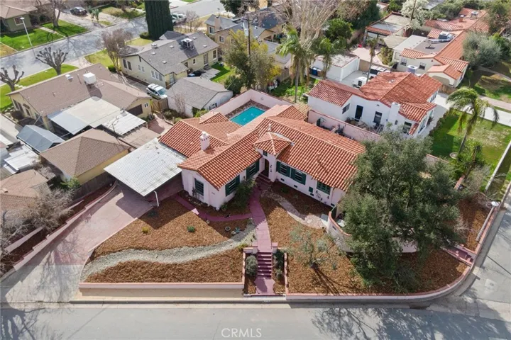 Aerial View: from east side, front steps from street to main entry at center, side steps from street at right lead to gate to side yard and backyard and access to Sun Room and North Bedroom entry doors.

