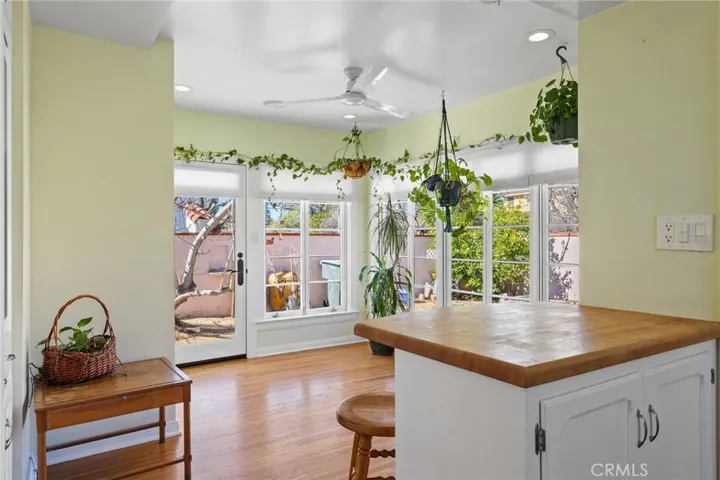 Sun Room/Office: original hardwood flooring, beautiful windows, new insulated shades, door to backyard, breakfast bar, new ceiling fan, ceiling speaker for sound system, ceiling can lights.

