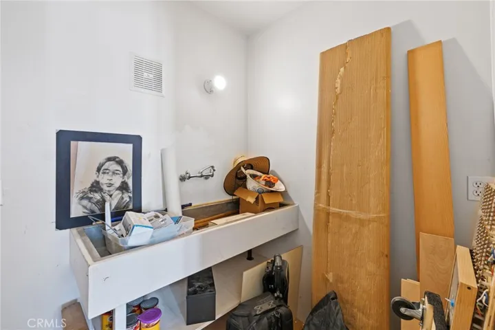 South (3rd) Bedroom: closet/darkroom detail view, large stainless steel sink, exhaust fan, electrical outlets, hardboard flooring, with extra electrical in walls and plumbing and drain lines in the walls and floor it could easily be converted into a 3rd full bathroom.

