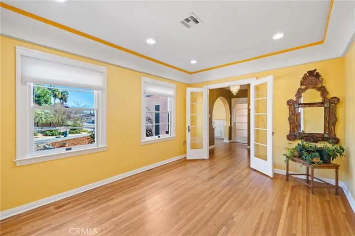Formal Dining Room: classic large full-sized room, seat 10-12+, original hardwood flooring, coved & trayed ceiling, french doors, oversized windows, new insulated shades, almost all windows throughout the house feature custom interior pull-down screens, newer recessed dimmable ceiling can lights.