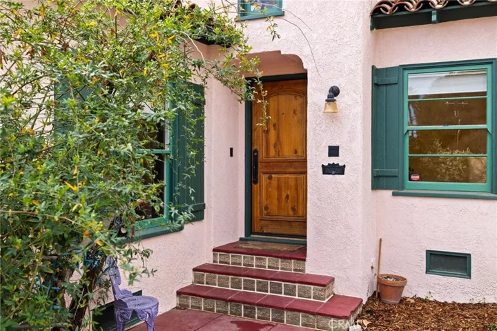 Front Main Entry: sculpted arch covered entry, custom wood door, period hardware, custom tiled steps, entire exterior is freshly painted in 3-toned exterior paint scheme, through-the-wall mailslot for security-they still do to-the-door/mailslot delivery in the La Cresta neighborhood, beautifully textured stucco.

