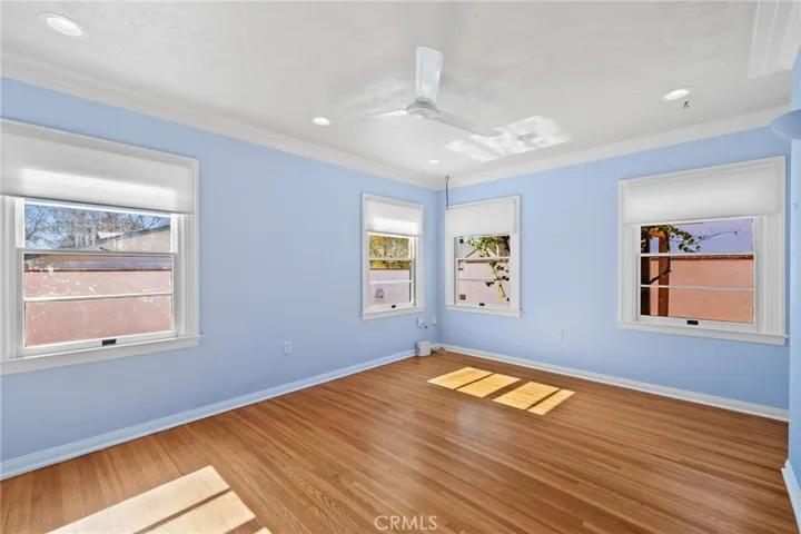 Middle Bedroom: extra large-sized, original hardwood flooring, lots of windows, new ceiling fan, recessed dimmable ceiling can lights, new insulated shades.


