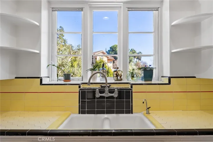 Kitchen: Sink & countertops detailed view, new faucet, original 4-toned tile countertops & full backsplashes.

