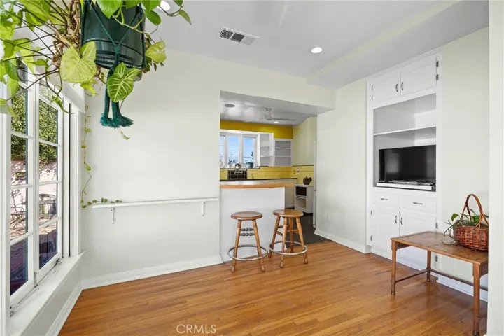 Sun Room/Office: opposite view, original hardwood flooring, ceiling can lights, built-in deep cabinet unit-could a closet for possible 4th bedroom conversion.

