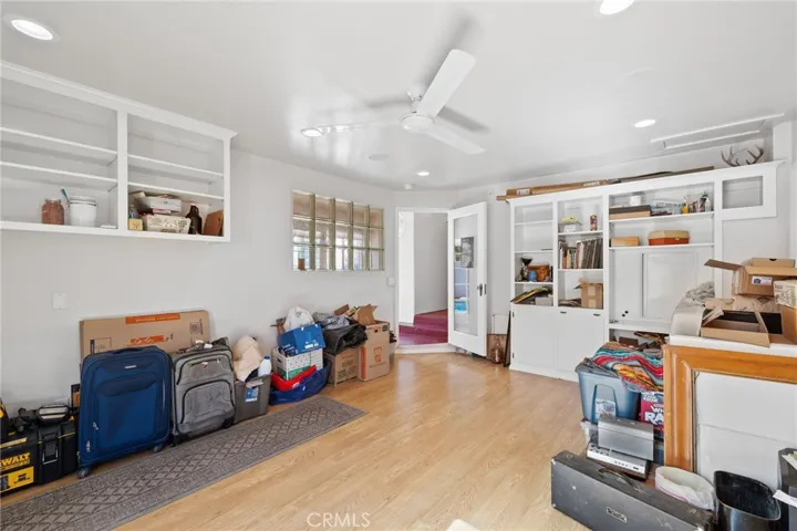 South (3rd) Bedroom: opposite view, large built-in cabinet wall unit, french-paned breezeway entry door, glass block wall insert.

