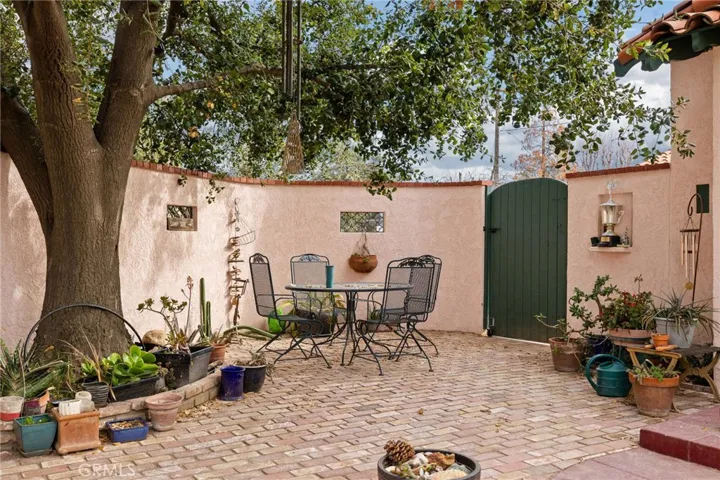North Side Yard Patio: detail view, gate to front yard and front main entry, kitchen back door just out of view at right.

