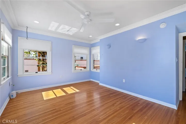 Middle Bedroom: view towards hallway door, custom wall sconces, wide sculpted mouldings, views to pool & spa and backyard.

