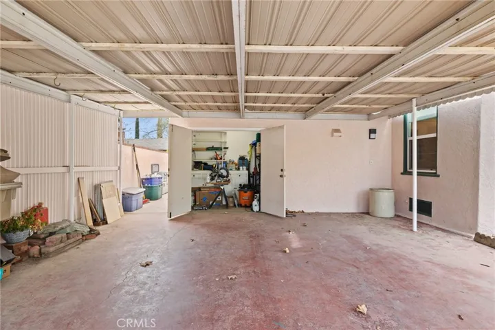 Carport: 2+ cars, level, heavy duty metal cover, 5'x10' shop/storage closet with built-in workbench, cabinets & shelves, side yard to gate to pool yard and to South (3rd) Bedroom entry door.

