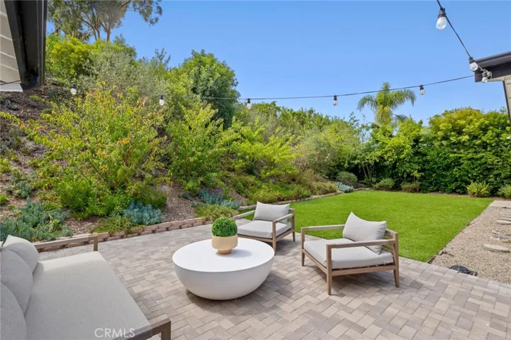 Large front and back yards extend the living space outdoors, creating an effortless indoor-outdoor connection ideal for coastal living.