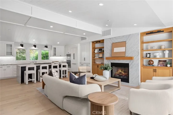 The airy, open layout showcases four generously scaled bedrooms and three-and-a-half elegantly finished baths.
