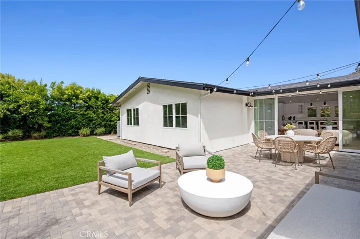 Step outside to a private backyard retreat, perfect for soaking in ocean breezes and serene surroundings.