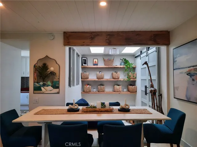 Dining area and bonus room with skylights