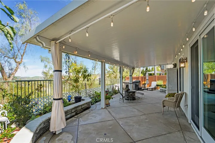This backyard offers a custom patio cover with lighting!