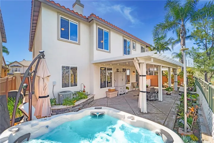 Bubbling jacuzzi compliments this lovely yard!