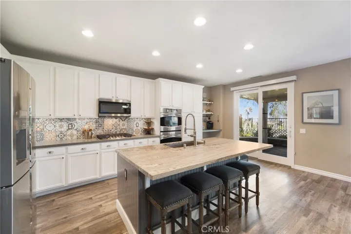 Remodeled, gourmet kitchen with double ovens, s.s. appliances and gorgeous slab counters!!