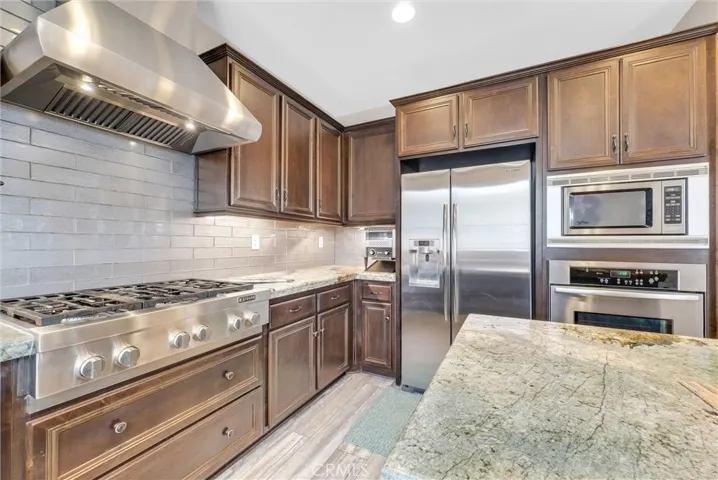 Jenn Air gas cooktop and pro vented hood.
