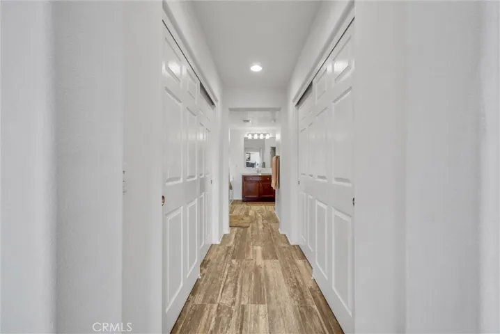 Hallway to dual closet and en suite primary bathroom
