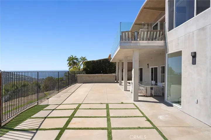 Downstairs flat enclosed backyard with ocean and mountain views