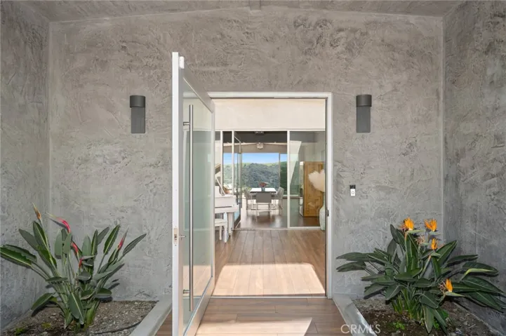 Glass door opening up to the grand foyer