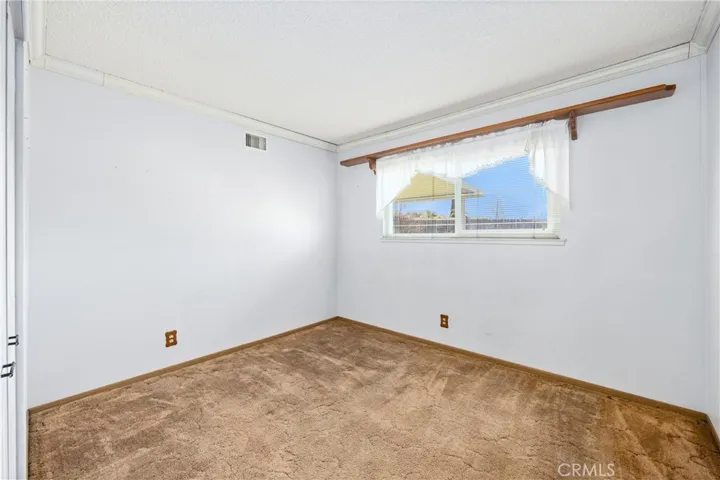 Bedroom 1 down hallway with window to backyard