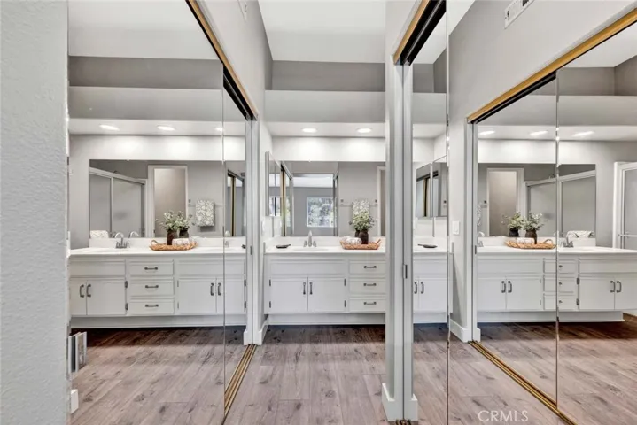 Two mirrored closets in primary bedroom