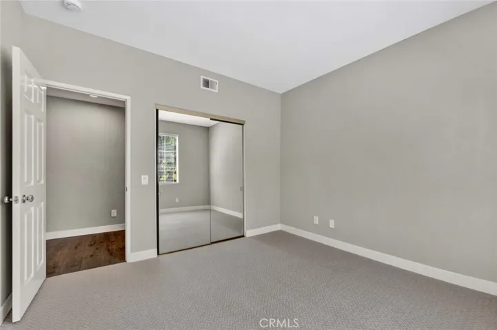 Mirrored closet doors in guest bedroom