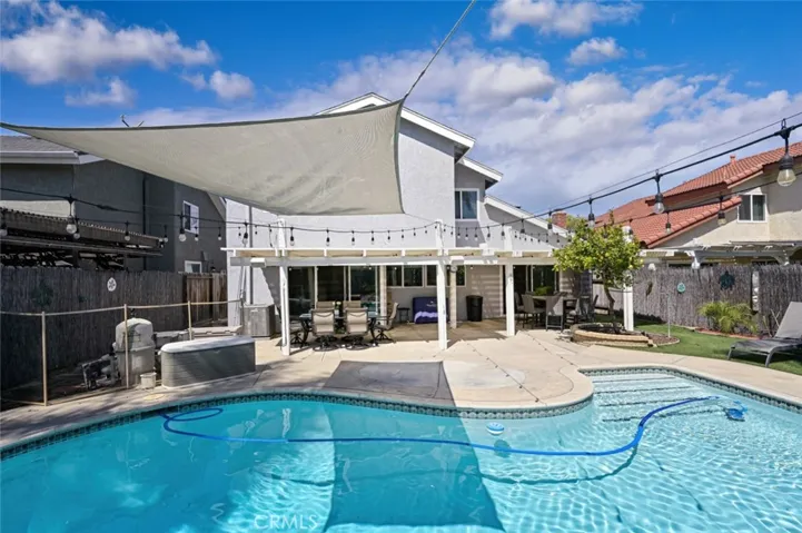The pool has a removable fence that is rolled up and stored on the side of the house.