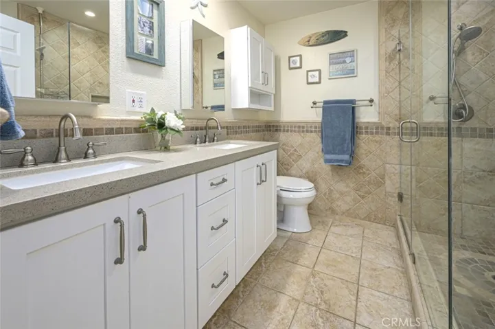 Primary Bathroom has a new double sink vanity with quartz countertop and 2 mirrored medicine cabinets.   
