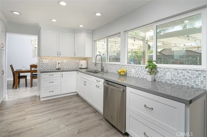 The wall of windows in the remodeled kitchen looks out into the backyard.
