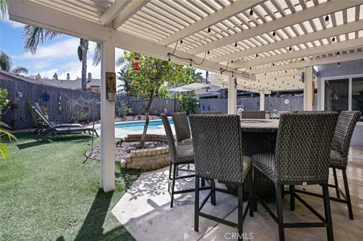 Backyard features turf on the side and a recently rebuilt patio cover.