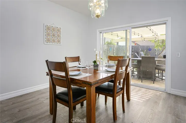 The dining room has a sliding glass door that opens up to the backyard.
