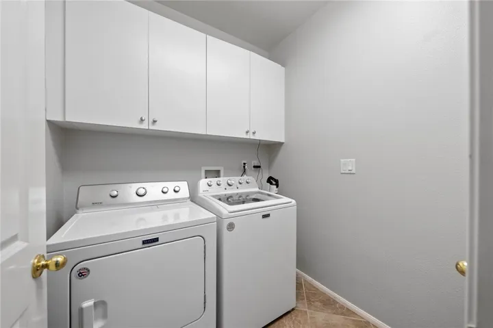 Main floor laundry with cabinets + storgage closet