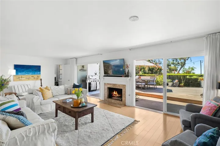 Providing a delightful setting for entertaining with the special people in your life, the main living area is bathed in natural light and offers a broad view of the ocean, all while opening to the deck, which creates an enviable indoor/outdoor aesthetic.