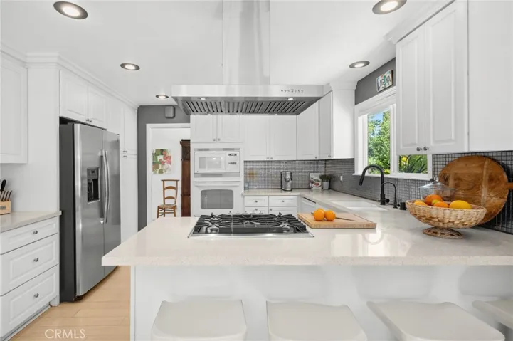 The dining room flows directly to a fully appointed kitchen, where chefs of all skill levels will appreciate a suite of appliances and ample storage.