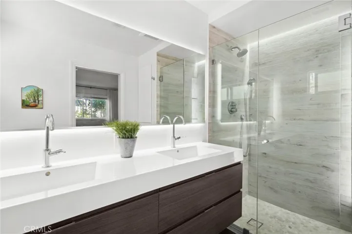 Renovated baths offer enduring style, and the attached garage includes a driveway with two off-street spaces.