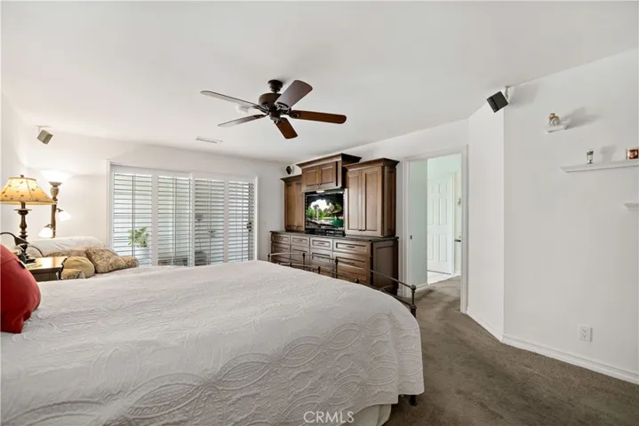 Primary bedroom w sliding doors to private patio area.