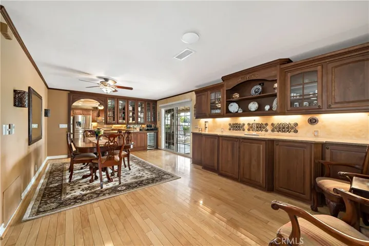 Hardwood flooring throughout main living areas including this ovesized dining room/multi purpose area perfect for casual dining or larger gatherings with PLENTY of additional cabinet storage space.