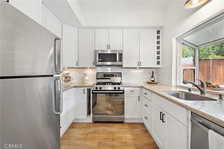 Freshly painted kitchen with stainless steel appliances.