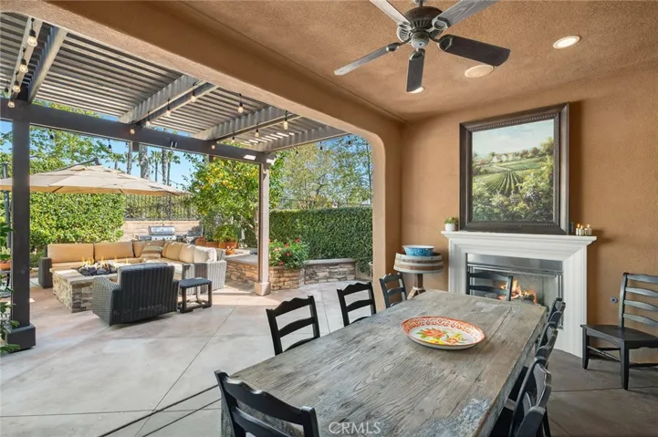 Covered dining space with adjoining fireplace