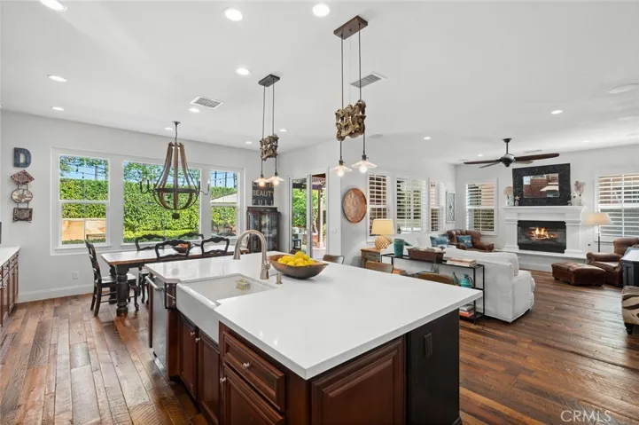Oversized island with single basin farmhouse sink and quartz countertops