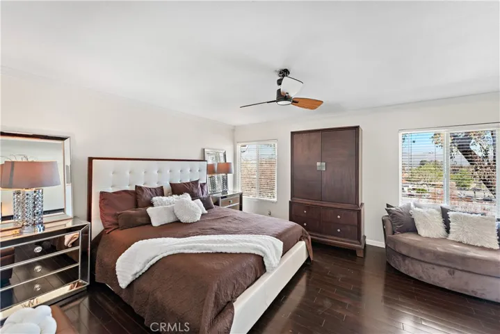 The larger primary bedroom boasting tile flooring, new window blinds and a to-die-for view.