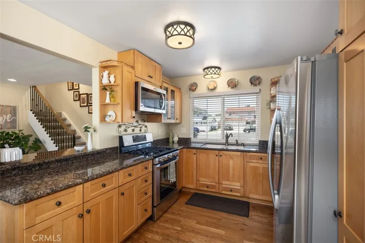 Beautiful wood cabinets with granite countertops & stainless steel appliances.