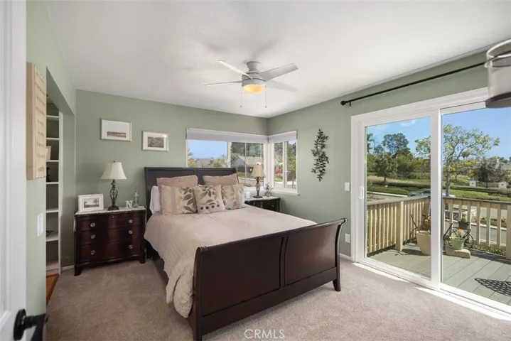 Spacious primary bedroom with large slider that opens up to the balcony.
