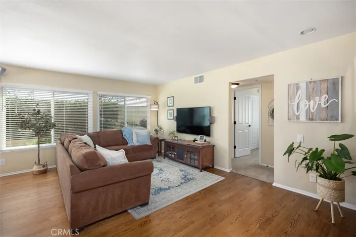 Living room with large double pane windows for natural lighting.