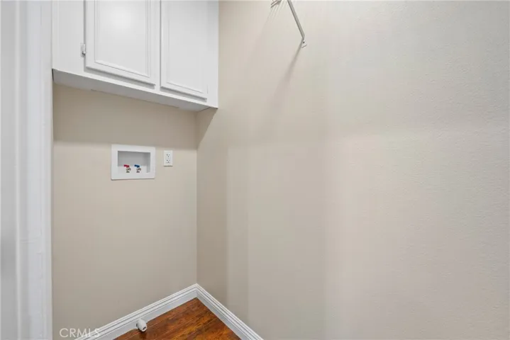 Built-in shelving provides extra storage for laundry essentials.