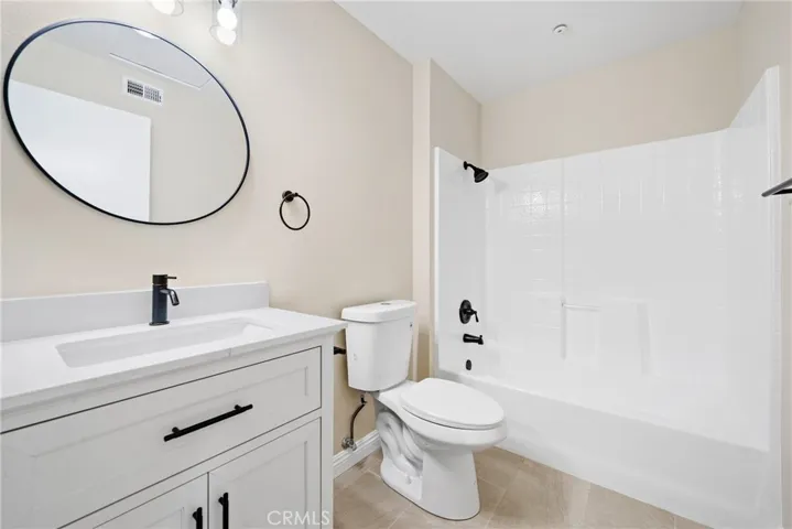The remodeled hallway bath features modern updates and a clean design.