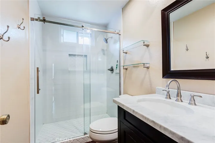 Fully remodeled hall bathroom with walk in shower, new vanity, mirror, sink, faucet, mirror