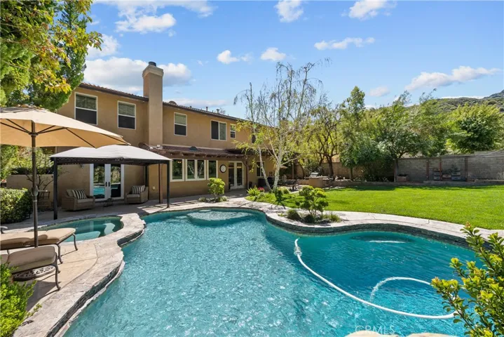 Resort-Style Heated Saline Pool and Raised Spa with Sun Deck and Waterfall