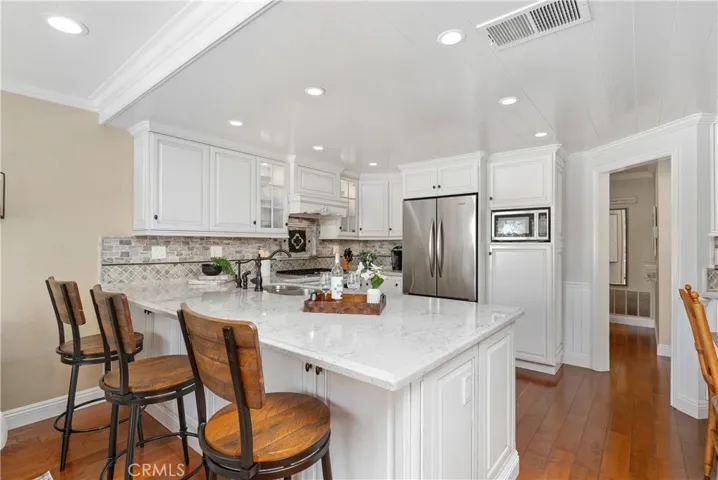 Enlarged island with Quartz counters and custom cabinetry!